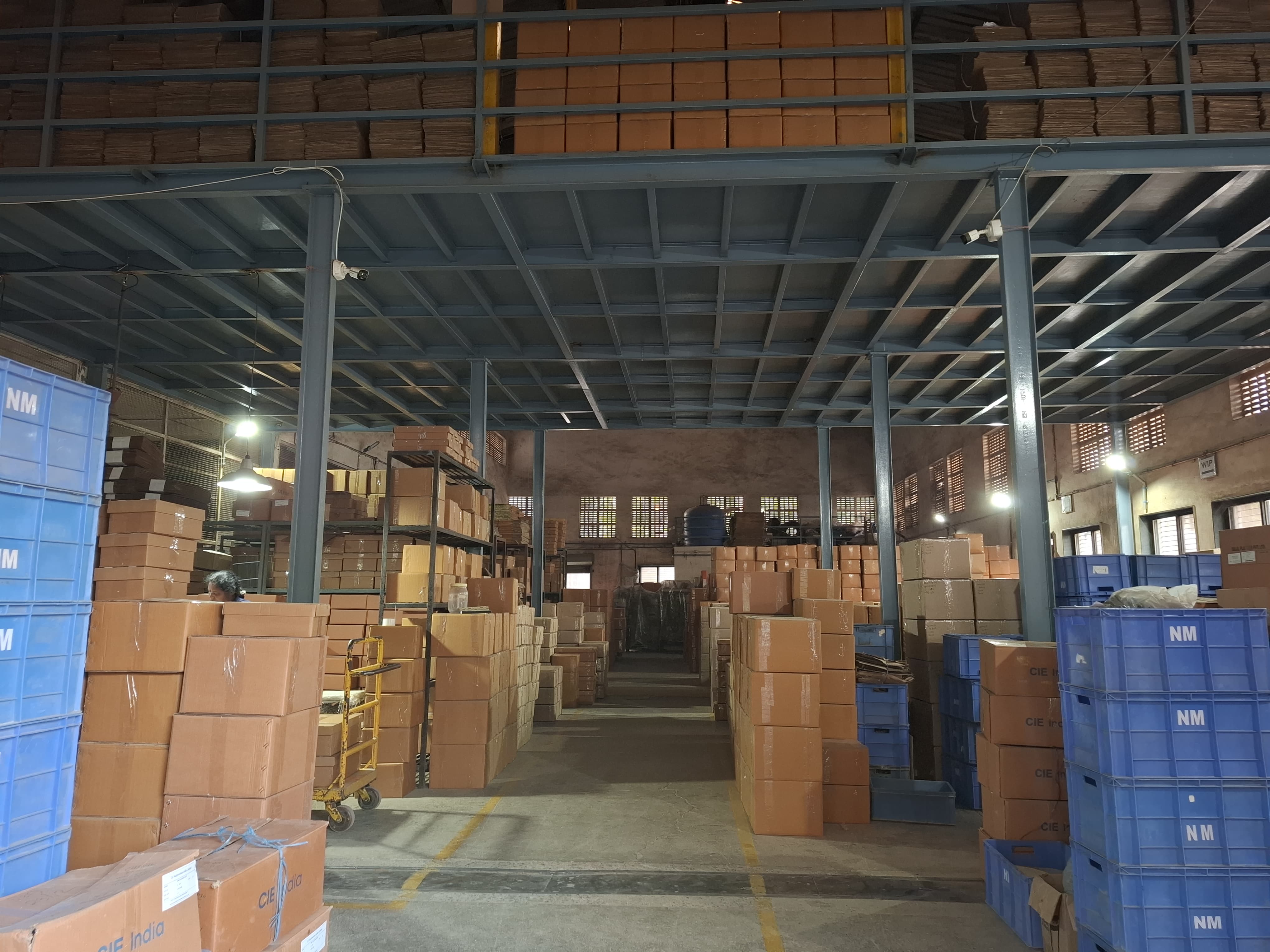 Natraj Moulds warehouse with stacked cartons and storage bins
